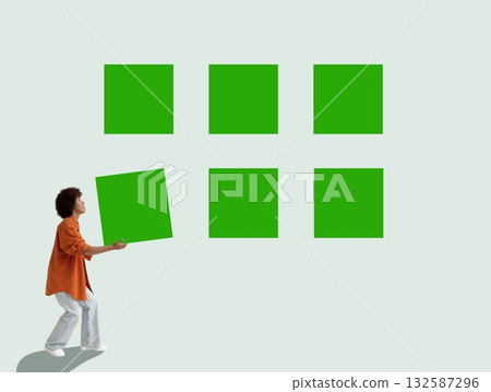 Person arranging green squares symbolizing creative problem solving. Person arranging green squares symbolizing creative problem solving. 132587296