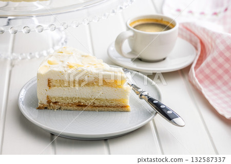 Sweet creamy cake on plate on white table. 132587337