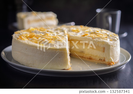Sweet creamy cake on plate on black table. Sweet creamy cake on plate on black table. 132587341