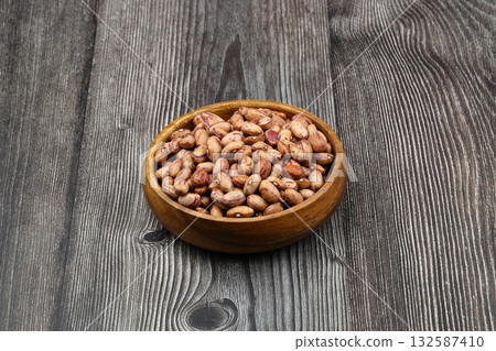 red kidney beans in wooden bowl isolated on dark background. 132587410