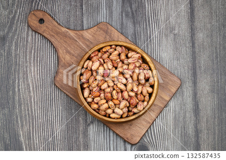 red kidney beans in wooden bowl isolated on dark background. 132587435