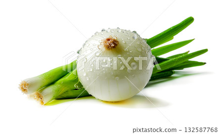 A white onion with water droplets on top of it next to some green onions 132587768