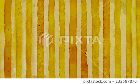 A yellow and white striped fabric with a yellow stain 132587876