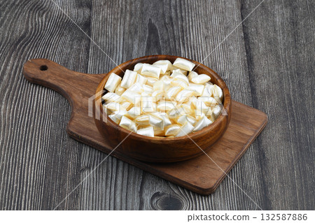 White sugar in a wooden bowl on a wooden background. Ramadan Feast candy. 132587886