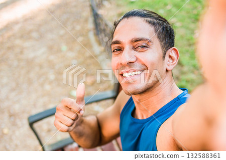 Disabled mid man latin athlete smiling giving thumbs up selfie 132588361