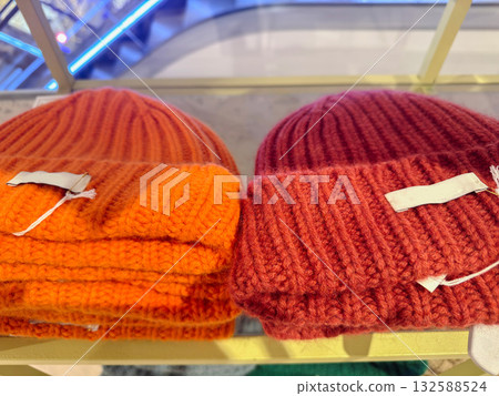 Trendy knitted hats displayed on store shelf Trendy knitted hats displayed on store shelf 132588524