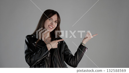 Young woman pointing aside with index fingers showing blank copy space Young woman pointing aside with index fingers showing blank copy space 132588569