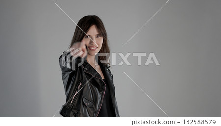 Rocker woman pointing finger at you with smiling expression 132588579