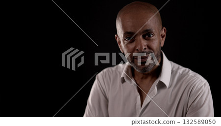Confident African American businessman posing on dark background 132589050