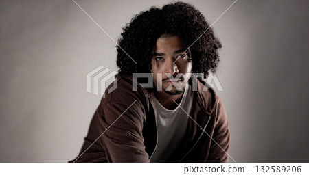 Young african american man with curly hair posing in studio Young african american man with curly hair posing in studio 132589206