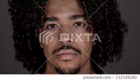 Portrait of serious young african american man with curly hair and goatee looking at camera Portrait of serious young african american man with curly hair and goatee looking at camera 132589260