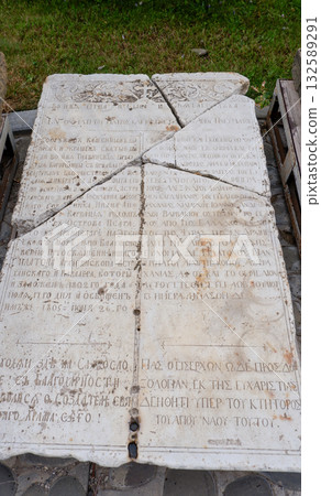 A stone tombstone with a crack with a Christian prayer on the territory of the historical and architectural complex of the Astrakhan Kremlin 132589291