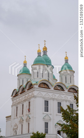 View of the Astrakhan Kremlin with the Assumption Cathedral and the bell tower on a cloudy day. Astrakhan, Russia 132589369