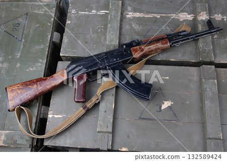 Kalashnikov AK 47 gun on army green crates Kalashnikov AK 47 gun on army green crates 132589424