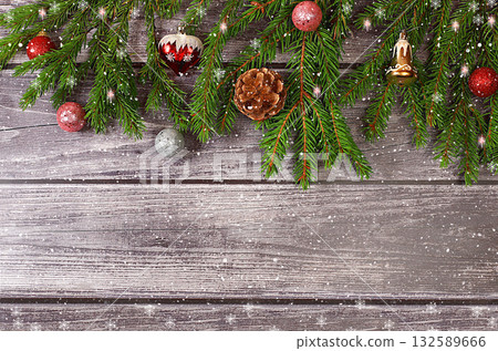 Christmas and New Year 2024 background with fir branches covered with snowflakes on a wooden table, toys and decorations, banner for holiday screen, template for design. Holiday card, selective focus, 132589666
