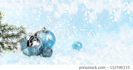 Christmas and New Year mockup for design, screen banner, festive composition with fir branches, cones and decorations on a snowy blue background with place for text, postcard, selective focus Christmas and New Year mockup for design, screen banner, festive composition with fir branches, cones and decorations on a snowy blue background with place for text, postcard, selective focus 132590155