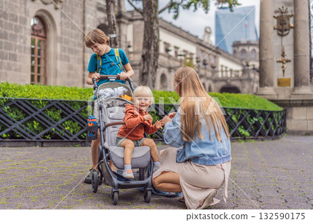 Mother with her two sons standing near Chapultepec Castle in Mexico City, enjoying sightseeing and family travel. Cultural heritage and tourism concept 132590175
