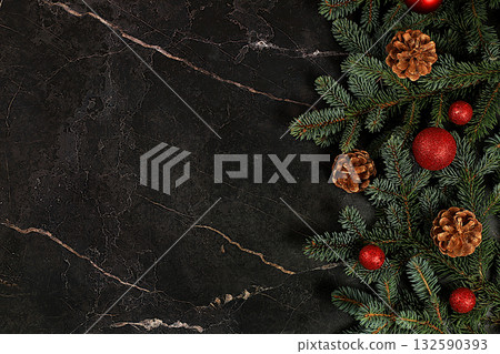 Christmas and new year 2025 composition, background with blue fir branches with holiday decorations on dark table, banner for holiday screen, template for design. Holiday card, selective focus, 132590393
