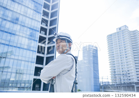 Worker wearing a full harness Worker wearing a full harness 132590434