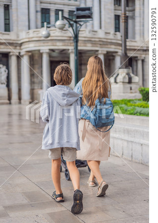 Mother tourist with her two sons in front of Palacio de Bellas Artes in Mexico City, enjoying family travel, architecture, and cultural heritage. Family travel and bonding concept 132590791