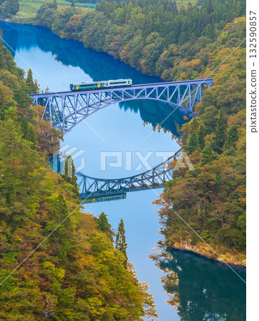 秋葉在山間盛開,一列火車駛過只見線的第一座橋。 秋葉在山間盛開,一列火車駛過只見線的第一座橋。 132590857