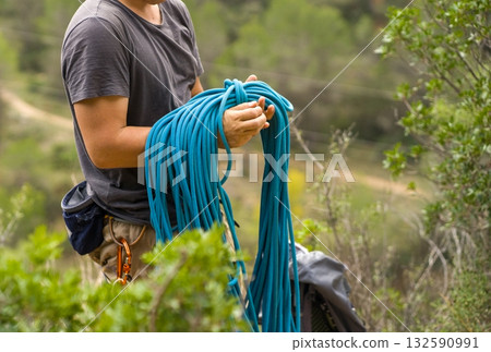 Man with a rope climbing in the mountains. Technical mountaineering. Man with a rope climbing in the mountains. Technical mountaineering. 132590991