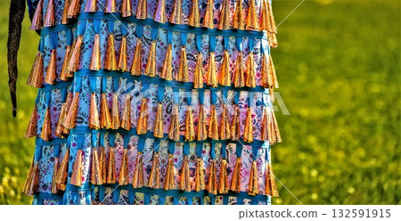 Colorful layered garment with tassels Colorful layered garment with tassels 132591915