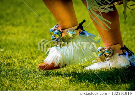 Traditional footwear with bells and fur on grass Traditional footwear with bells and fur on grass 132591919