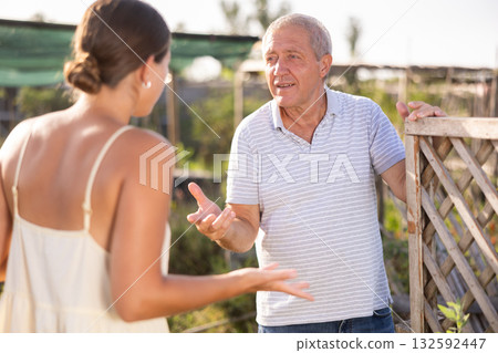 Conflict between neighbors, man and woman, in country farm Conflict between neighbors, man and woman, in country farm 132592447