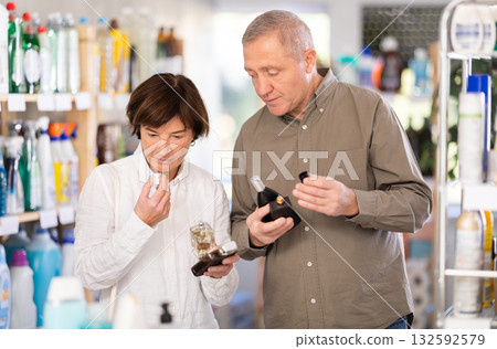 Elderly couple choosing perfume in store 132592579