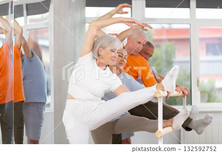 Ballet pose grand batman - elderly women and men at choreography lesson 132592752