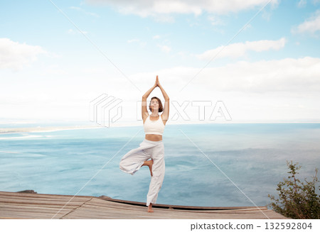 Fit woman in sportswear practicing Tree Pose yoga 132592804