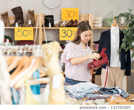 Teenager choosing a bag in a store 132592805