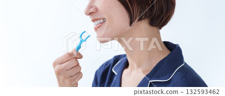 Woman using floss Woman using floss 132593462