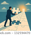 A man putting the last piece of a puzzle into place 132594470