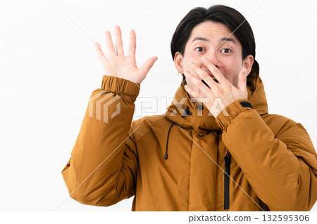 Young man wearing a down coat 132595306