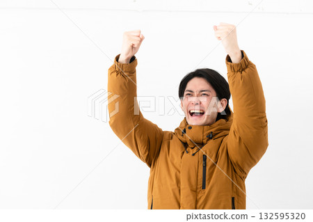 Young man wearing a down coat Young man wearing a down coat 132595320