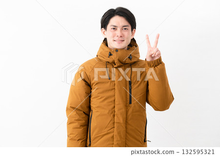 Young man wearing a down coat Young man wearing a down coat 132595321