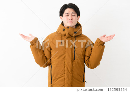 Young man wearing a down coat 132595334
