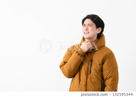 Young man wearing a down coat Young man wearing a down coat 132595344