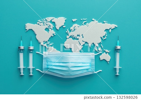 A blue background with a mask and syringes on it 132598026