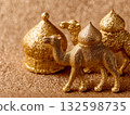Golden Camel and Dome Figurines on Glitter Surface 132598735