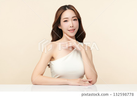 A beautiful young Asian woman with clean, fresh skin against a beige background. Skincare, facial treatment, cosmetology, beauty, and spa. An elegant portrait of an Asian woman. A beautiful young Asian woman with clean, fresh skin against a beige background. Skincare, facial treatment, cosmetology, beauty, and spa. An elegant portrait of an Asian woman. 132598778