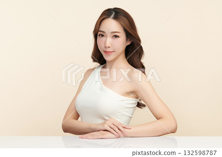 A beautiful young Asian woman with clean, fresh skin against a beige background. Skincare, facial treatment, cosmetology, beauty, and spa. An elegant portrait of an Asian woman. A beautiful young Asian woman with clean, fresh skin against a beige background. Skincare, facial treatment, cosmetology, beauty, and spa. An elegant portrait of an Asian woman. 132598787