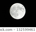 Full moon floating in the night sky 132599461