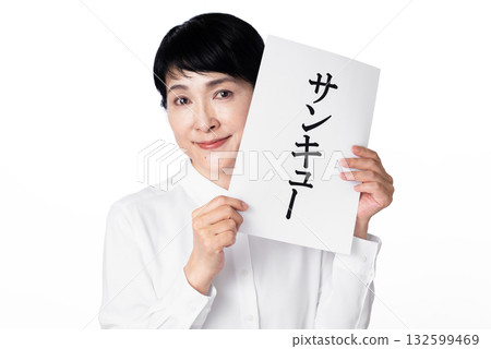 A smiling senior woman holding a piece of paper with the word thank you written on it in both hands A smiling senior woman holding a piece of paper with the word thank you written on it in both hands 132599469