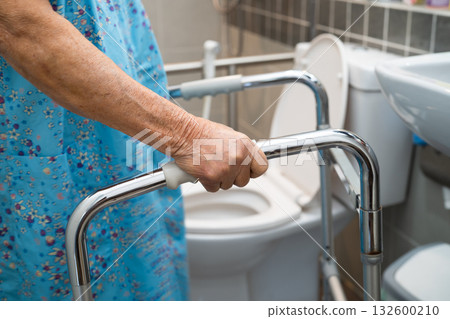 Asian elderly woman patient use walker and toilet bathroom handle security in nursing hospital, healthy strong medical. 132600210