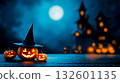 A couple of pumpkins sitting on top of a wooden table 132601135