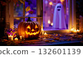 A jack-o-lantern sitting on a wooden table next to a window with candles and a ghost in the background 132601139