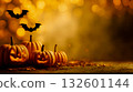 A group of pumpkins sitting on top of a table next to a bat 132601144